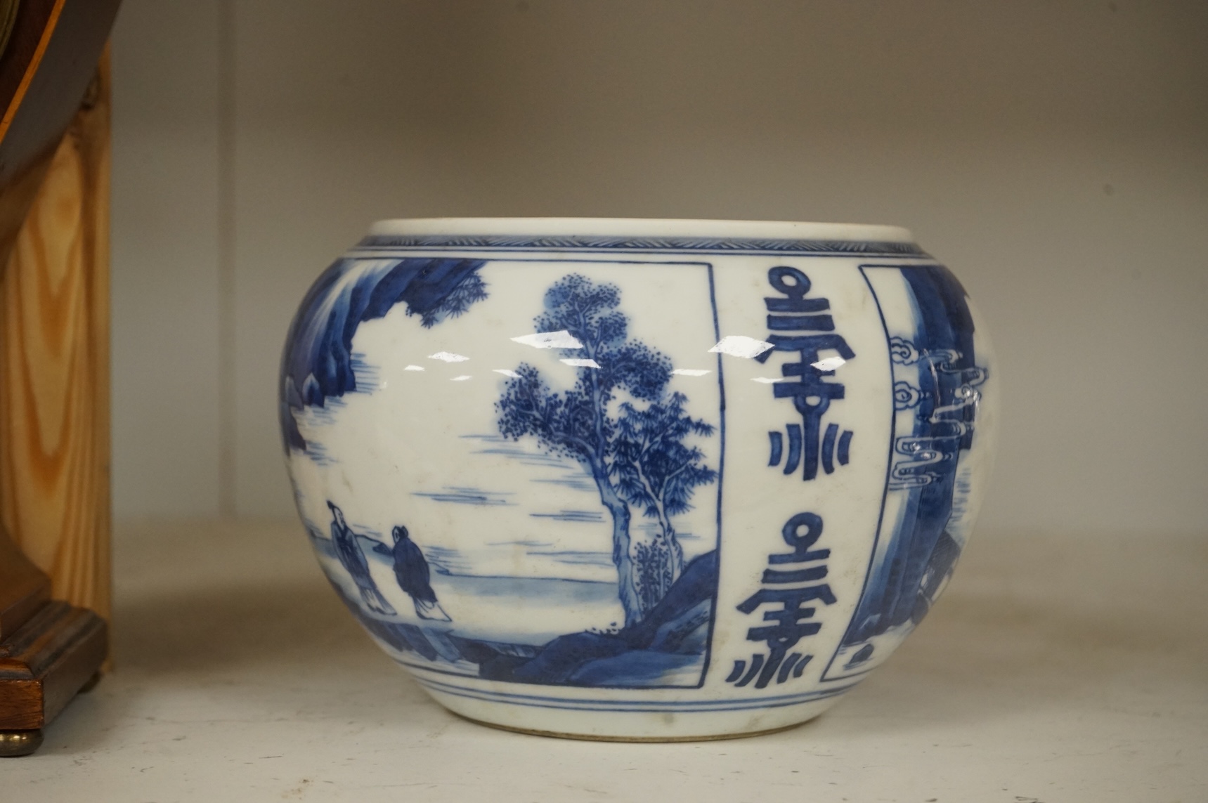 A Chinese blue and white water pot, decorated with two scenes in landscapes, 10.5cm high